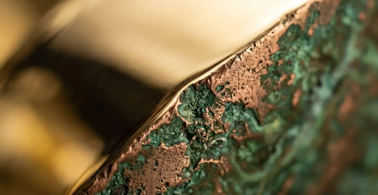 Visual metaphor contrasting gold's protective qualities against industrial commodity dynamics